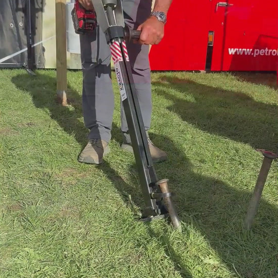 Xtracto removing various items from the ground; road pins, marquee pins, self-set tree saplings